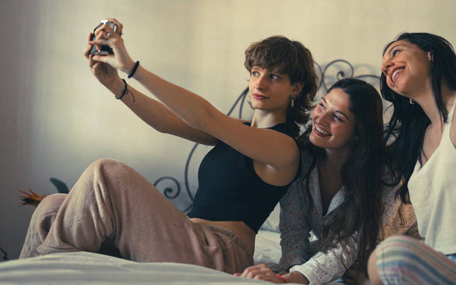 Three young women joyfully taking a selfie, capturing a moment of friendship and happiness.