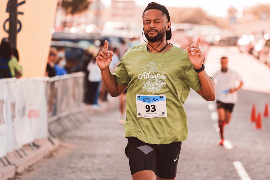 Male runner with eyes closed, deep in focus during a marathon race.