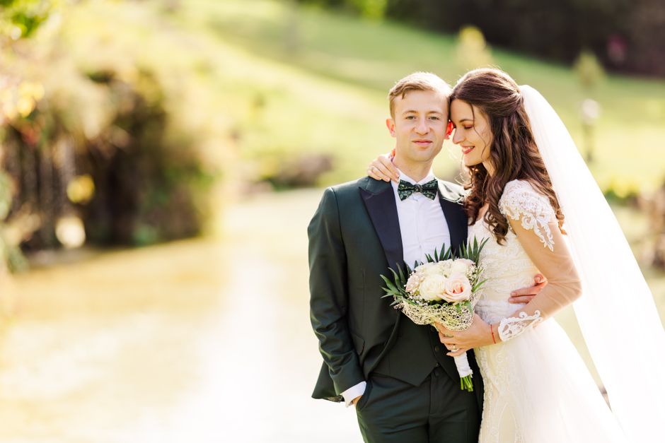 Elegant bride and groom in scenic Bușteni, Romania, enjoying their special day.