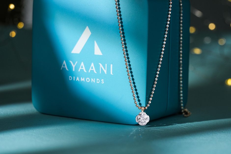 Elegant diamond pendant displayed with luxurious packaging, perfect for festive occasions.